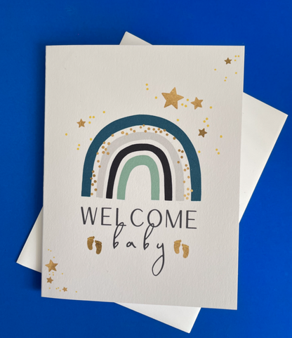 Welcome Baby rainbow blue greeting card with hand-applied sparkling details